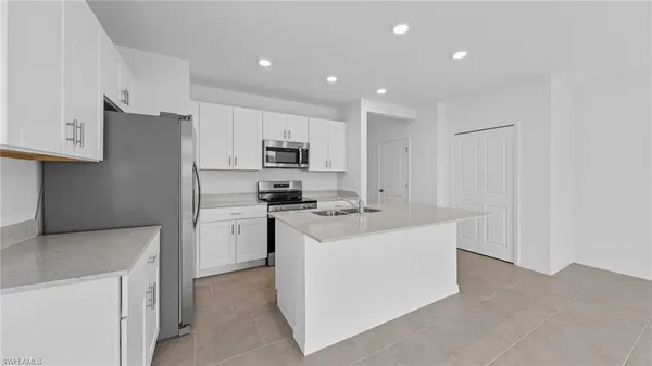 a kitchen with cabinets and stainless steel appliances