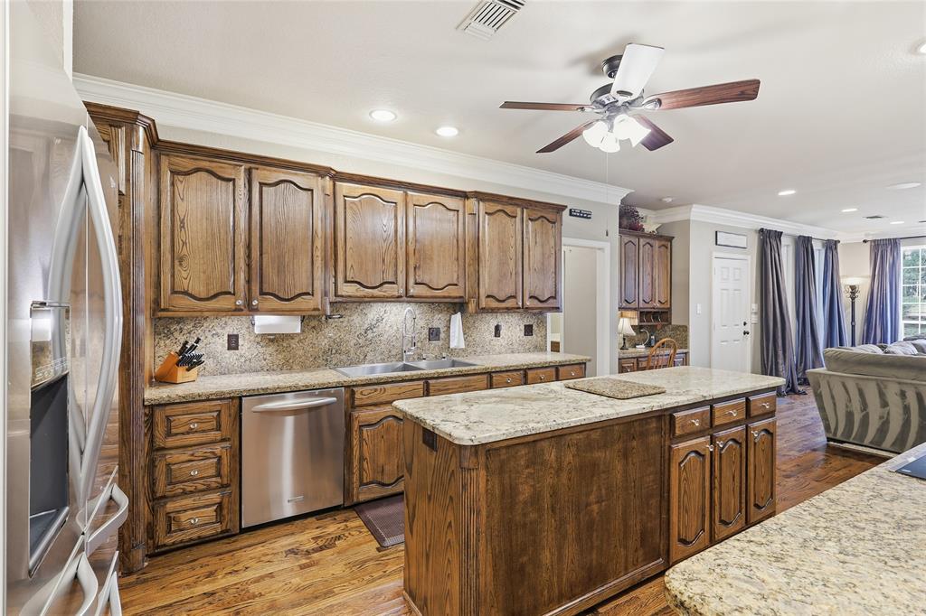 4800 Shiloh Road Double Oak, TX 75022 - Photo 14 of 40 a kitchen with stainless steel appliances granite countertop a sink a stove and a refrigerator