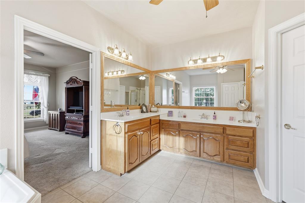 4800 Shiloh Road Double Oak, TX 75022 - Photo 18 of 40 a large bathroom with a large tub sink and cabinets