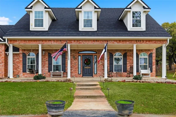 an aerial view of residential houses with outdoor space and trees