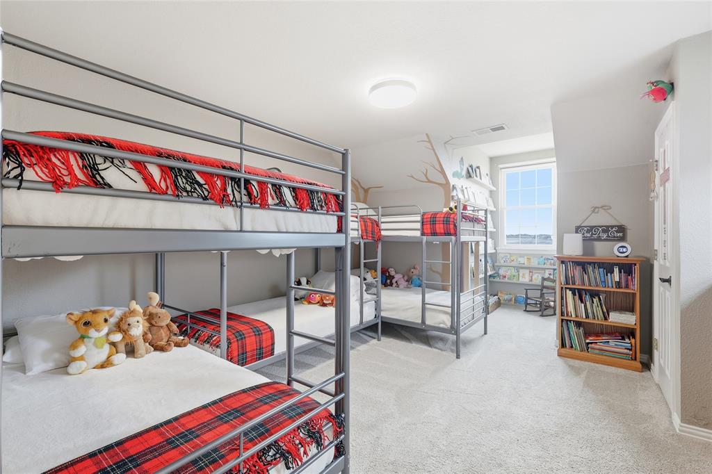 4800 Shiloh Road Double Oak, TX 75022 - Photo 24 of 40 a bedroom with a bed and a book shelf