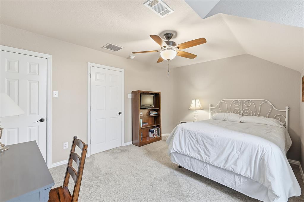 4800 Shiloh Road Double Oak, TX 75022 - Photo 27 of 40 a bedroom with a bed and a chandelier