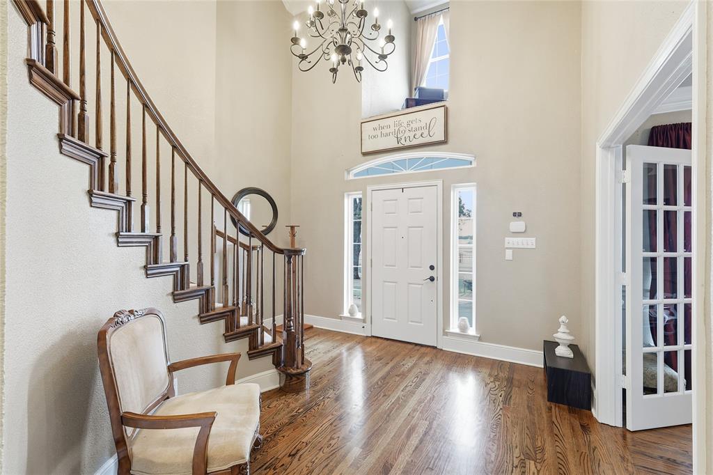 4800 Shiloh Road Double Oak, TX 75022 - Photo 9 of 40 a view of a hallway with wooden floor and staircase