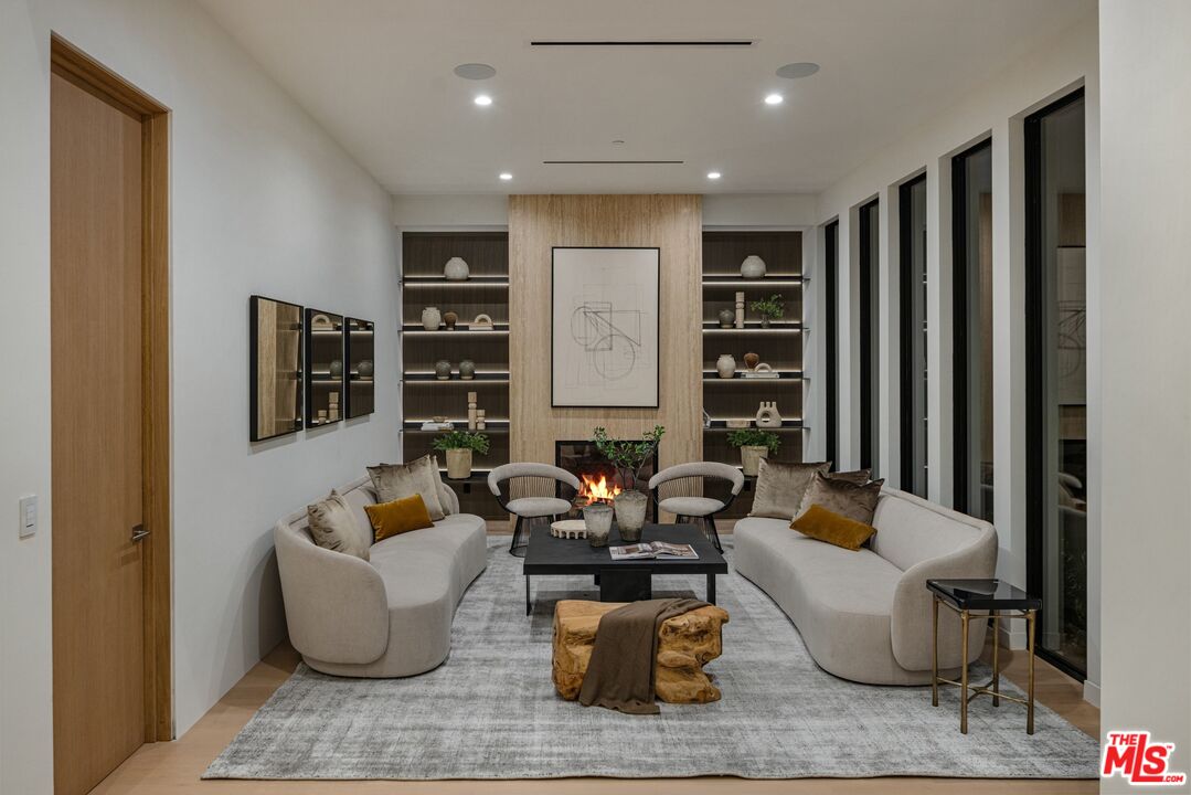 17055 Rancho Street Encino, CA 91316 - Photo 7 of 73 a living room with furniture and a potted plant
