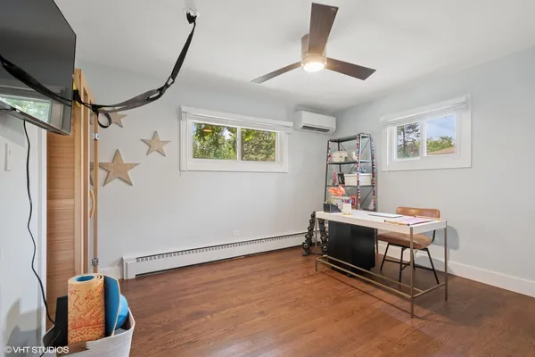a view of a workspace with furniture and a window