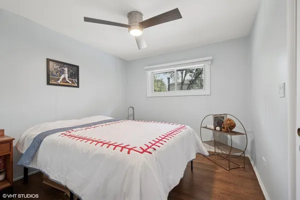 a bedroom with a bed and a painting on the wall