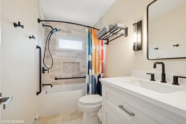 a bathroom with a sink toilet and shower