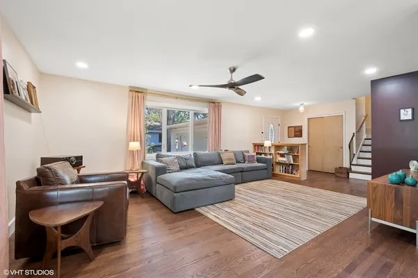 a living room with furniture and a wooden floor