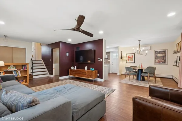 a living room with furniture and a wooden floor