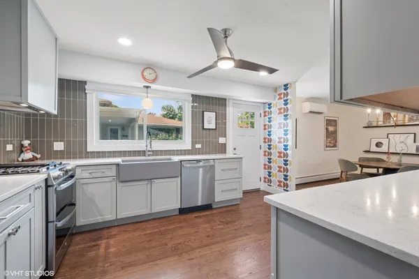 a large kitchen with cabinets a sink and appliances