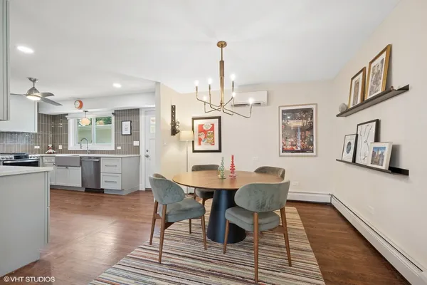 a view of a dining room with furniture and wooden floor