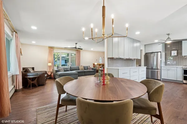 a view of a dining room with furniture and wooden floor