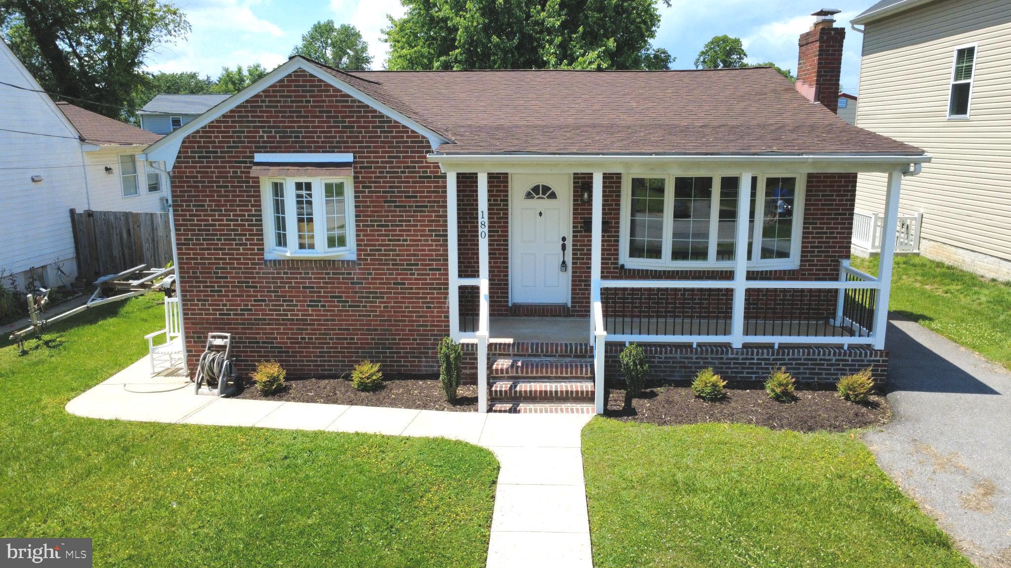 Charming brick home with inviting porch.