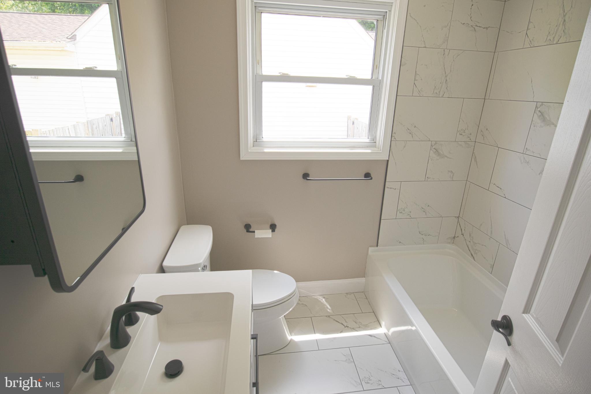 180 Carroll Road Pasadena, MD 21122 - Photo 13 of 28 Modern bathroom with natural light.