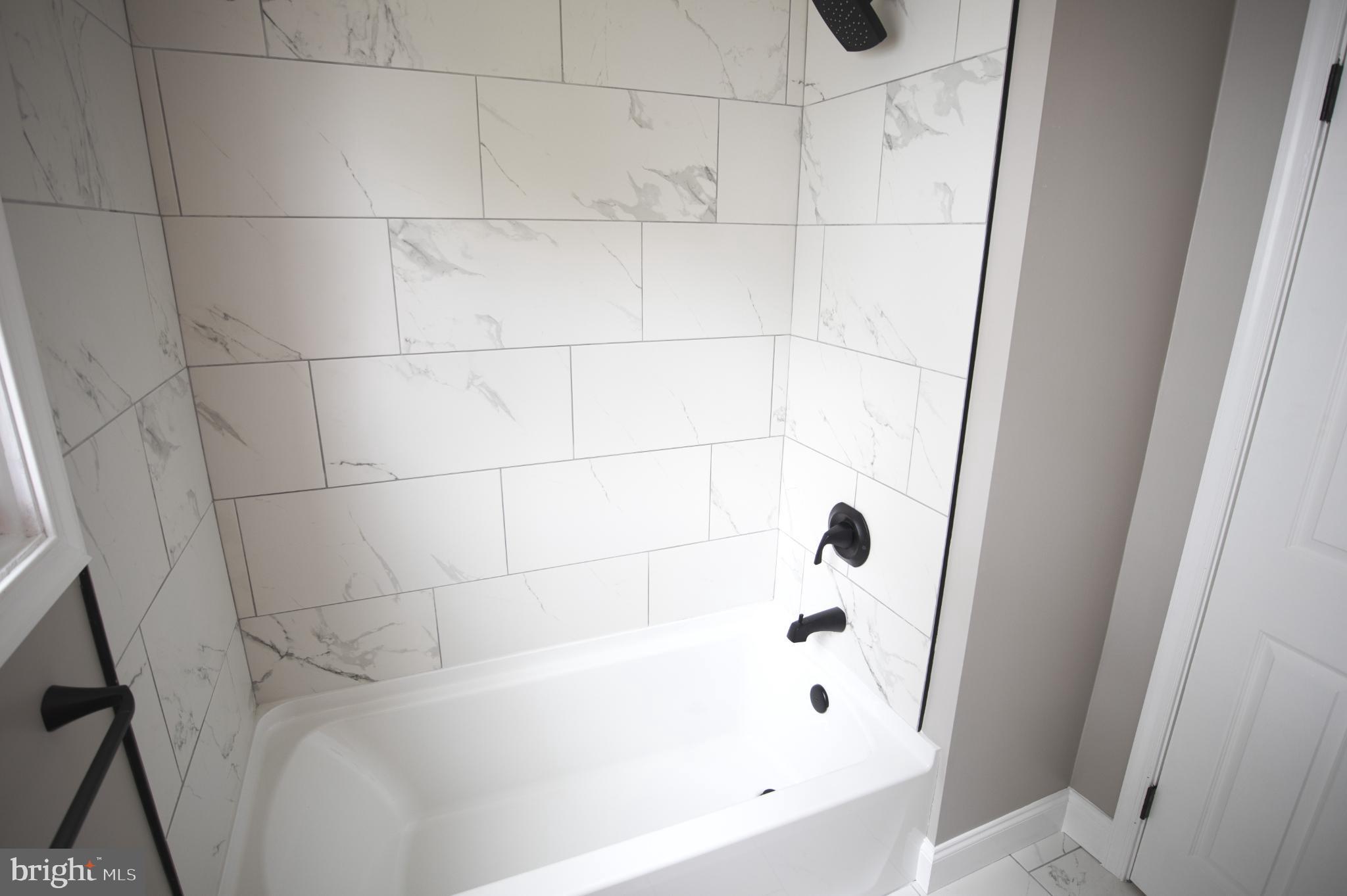180 Carroll Road Pasadena, MD 21122 - Photo 14 of 28 Elegant bathroom with modern marble tiles.