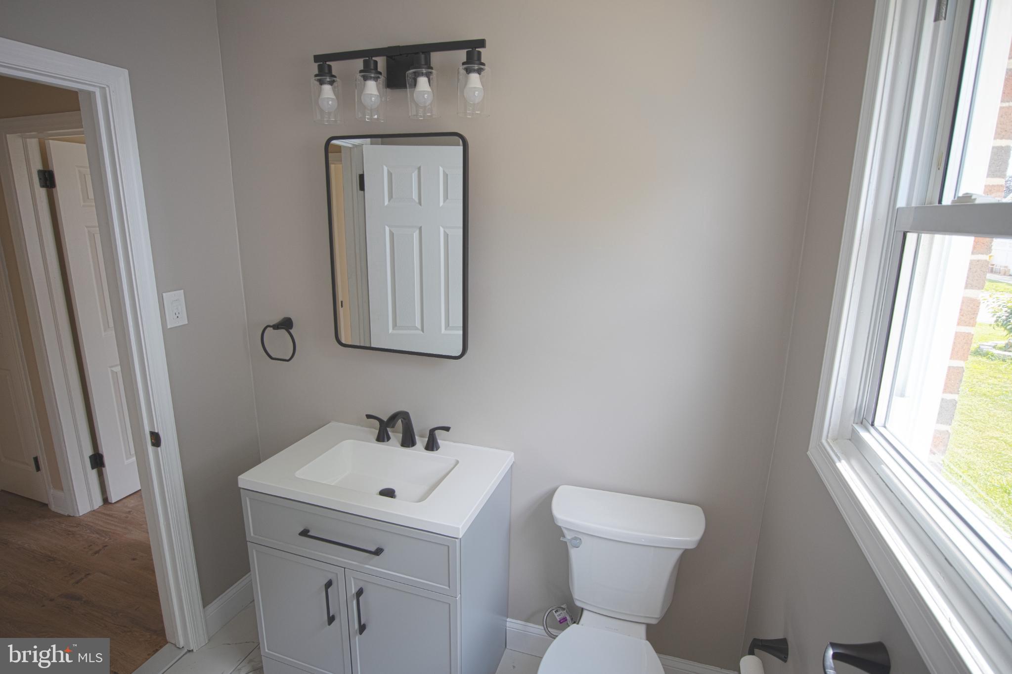 180 Carroll Road Pasadena, MD 21122 - Photo 15 of 28 Modern bathroom with sleek fixtures.