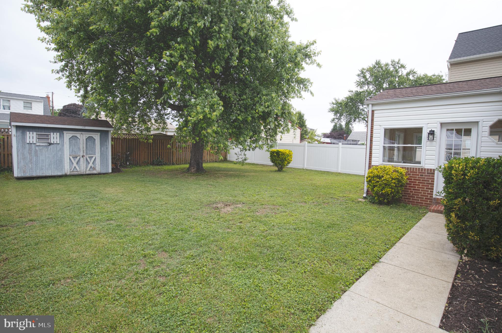 180 Carroll Road Pasadena, MD 21122 - Photo 22 of 28 Spacious yard with lush greenery and charm.