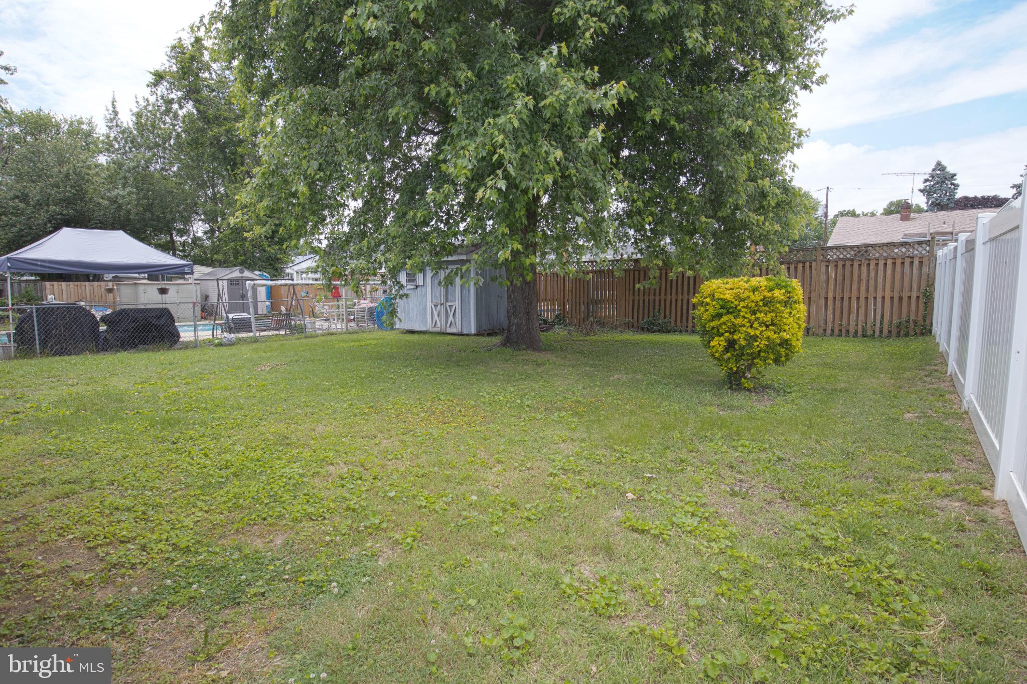 180 Carroll Road Pasadena, MD 21122 - Photo 23 of 28 Spacious backyard oasis with lush greenery.