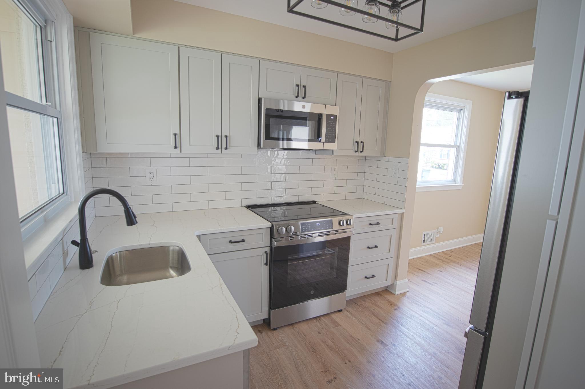 180 Carroll Road Pasadena, MD 21122 - Photo 8 of 28 Modern kitchen with sleek finishes.