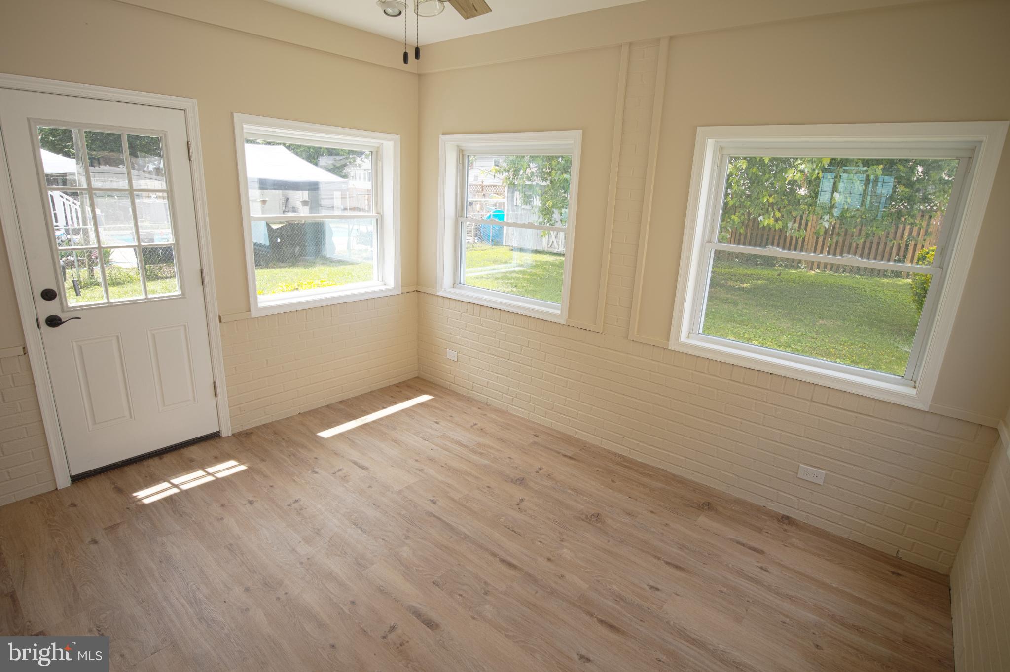 180 Carroll Road Pasadena, MD 21122 - Photo 9 of 28 Bright and airy sunroom with garden views.