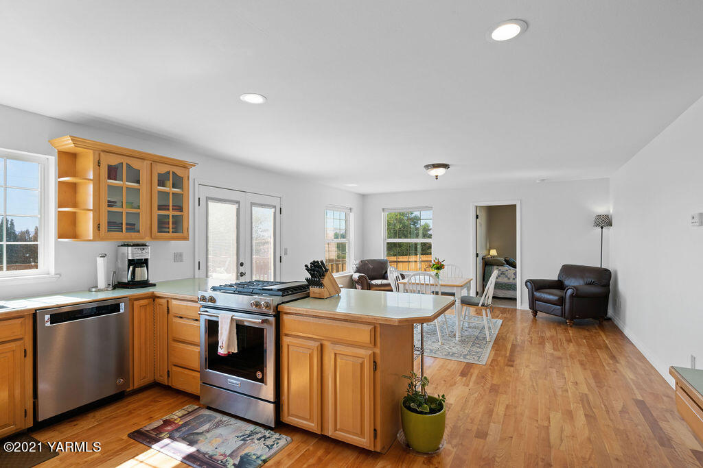 13050 West Barrett Road Yakima, WA 98908 - Photo 11 of 55 a kitchen with a sink a counter top space and living room area