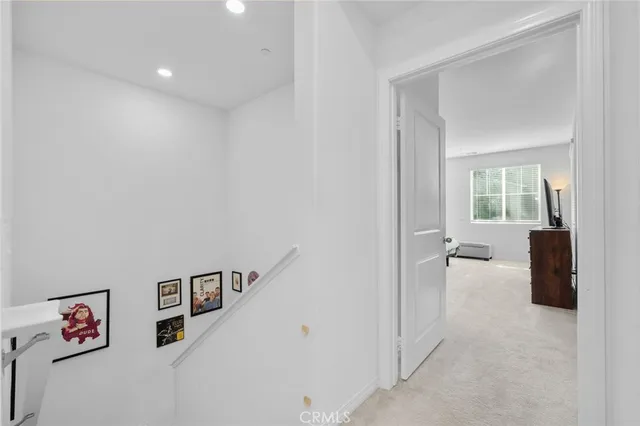 a view of hallway with livingroom and furniture