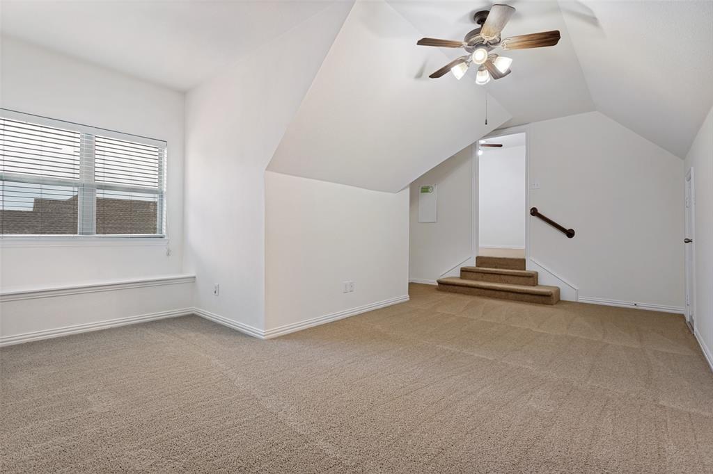1806 Caprock Road Allen, TX 75002 - Photo 20 of 33 Carpeted loft space featuring a multi-light ceiling fan, a window with horizontal blinds, and a built-in window bench