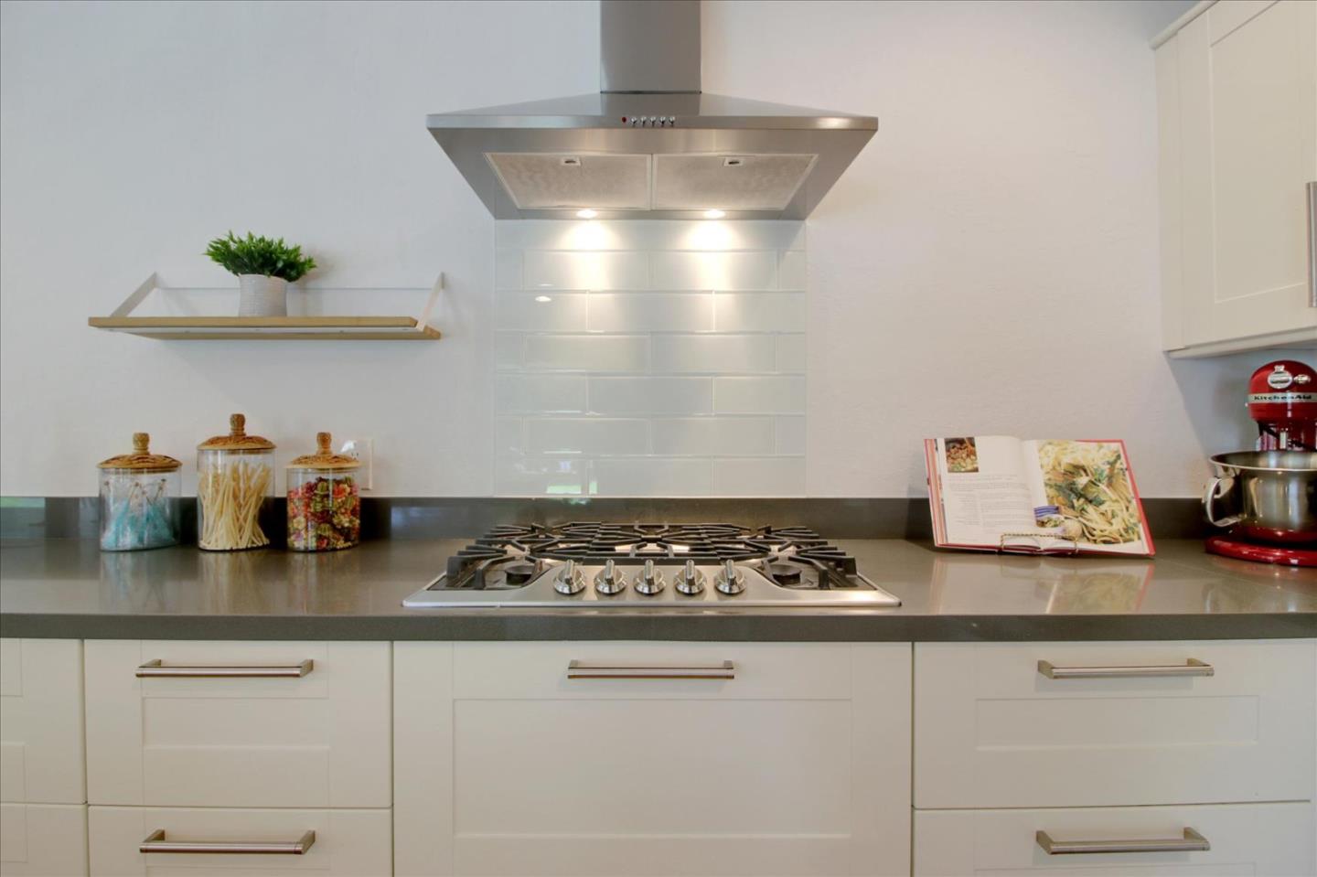 1435 Floyd Avenue Sunnyvale, CA 94087 - Photo 11 of 36 a kitchen with granite countertop stove top oven and cabinets