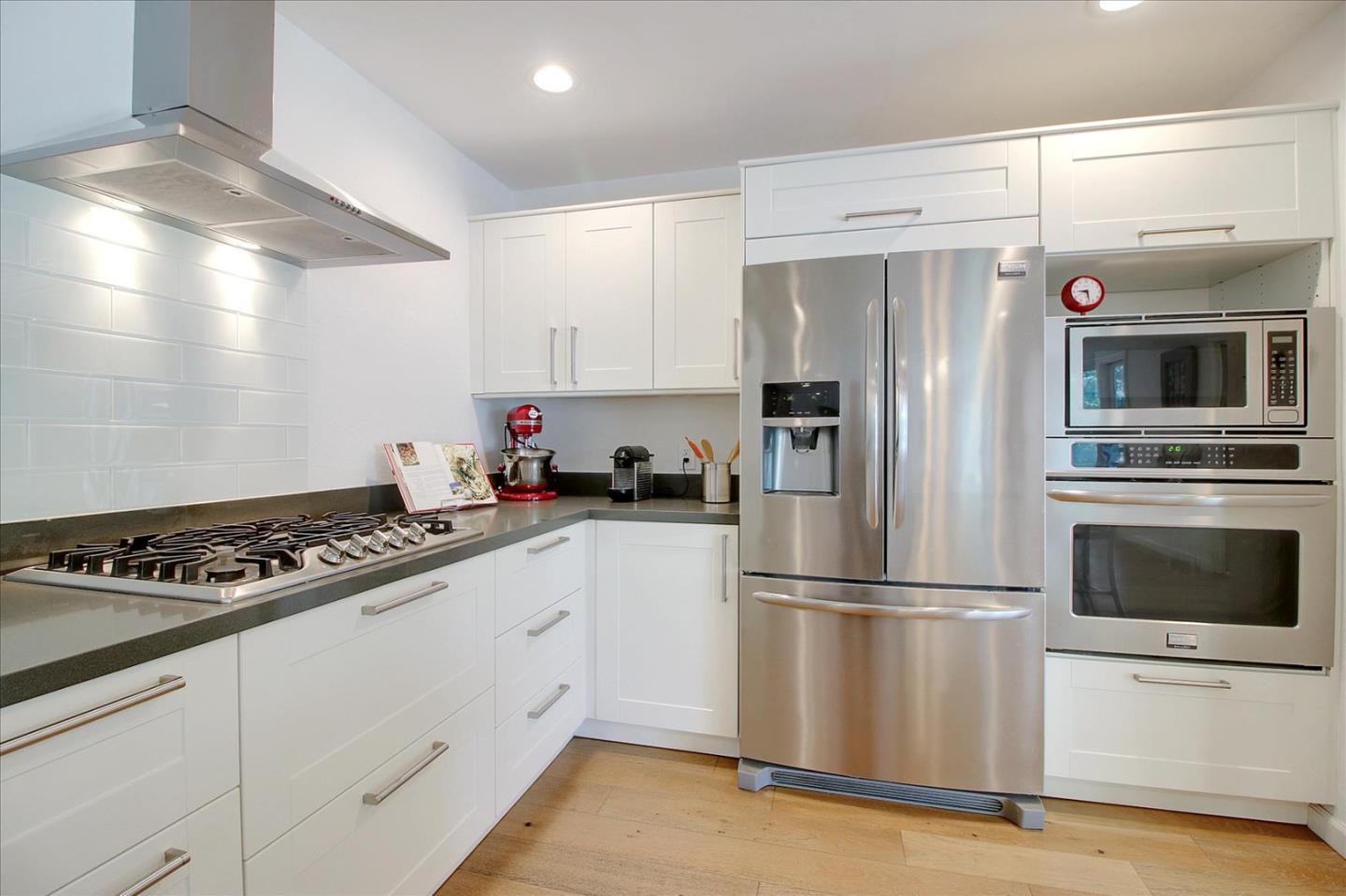 1435 Floyd Avenue Sunnyvale, CA 94087 - Photo 12 of 36 a kitchen with granite countertop a refrigerator stove and microwave