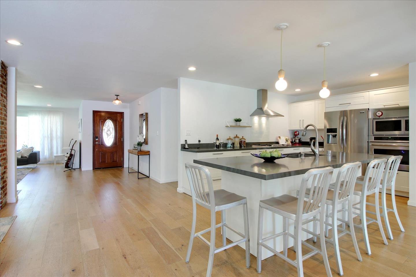 1435 Floyd Avenue Sunnyvale, CA 94087 - Photo 14 of 36 a kitchen with stainless steel appliances kitchen island granite countertop a table and chairs in it