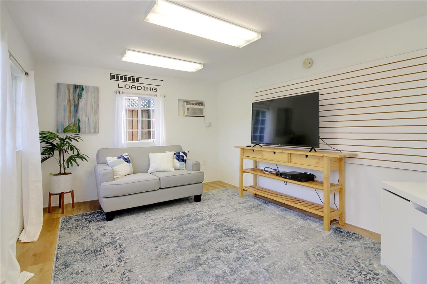1435 Floyd Avenue Sunnyvale, CA 94087 - Photo 15 of 36 a living room with furniture and a flat screen tv