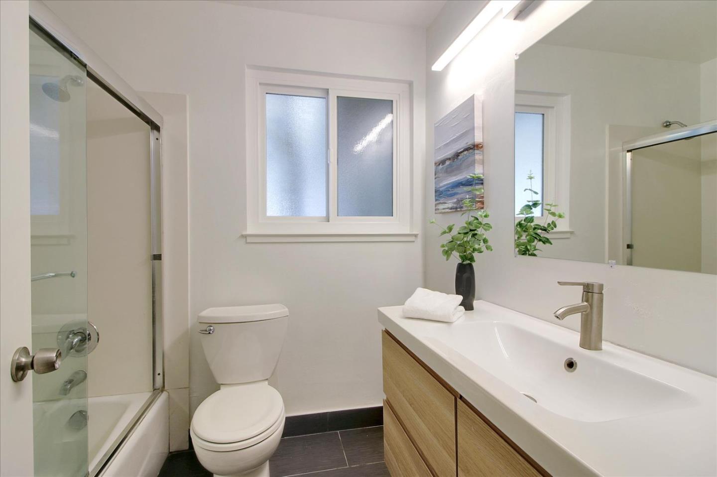 1435 Floyd Avenue Sunnyvale, CA 94087 - Photo 20 of 36 a bathroom with a toilet sink and mirror