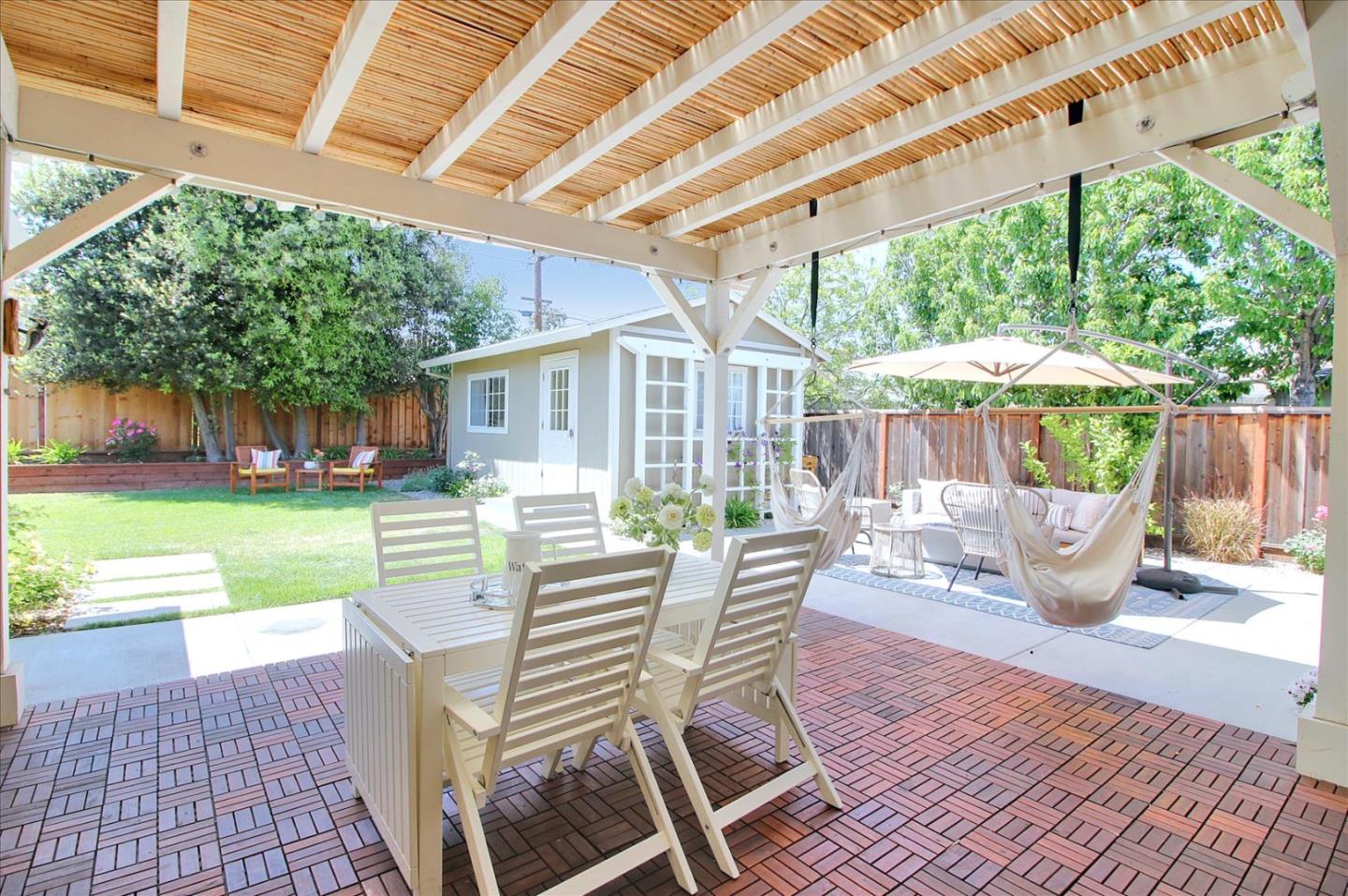 1435 Floyd Avenue Sunnyvale, CA 94087 - Photo 25 of 36 a view of a patio with a table chairs and a backyard