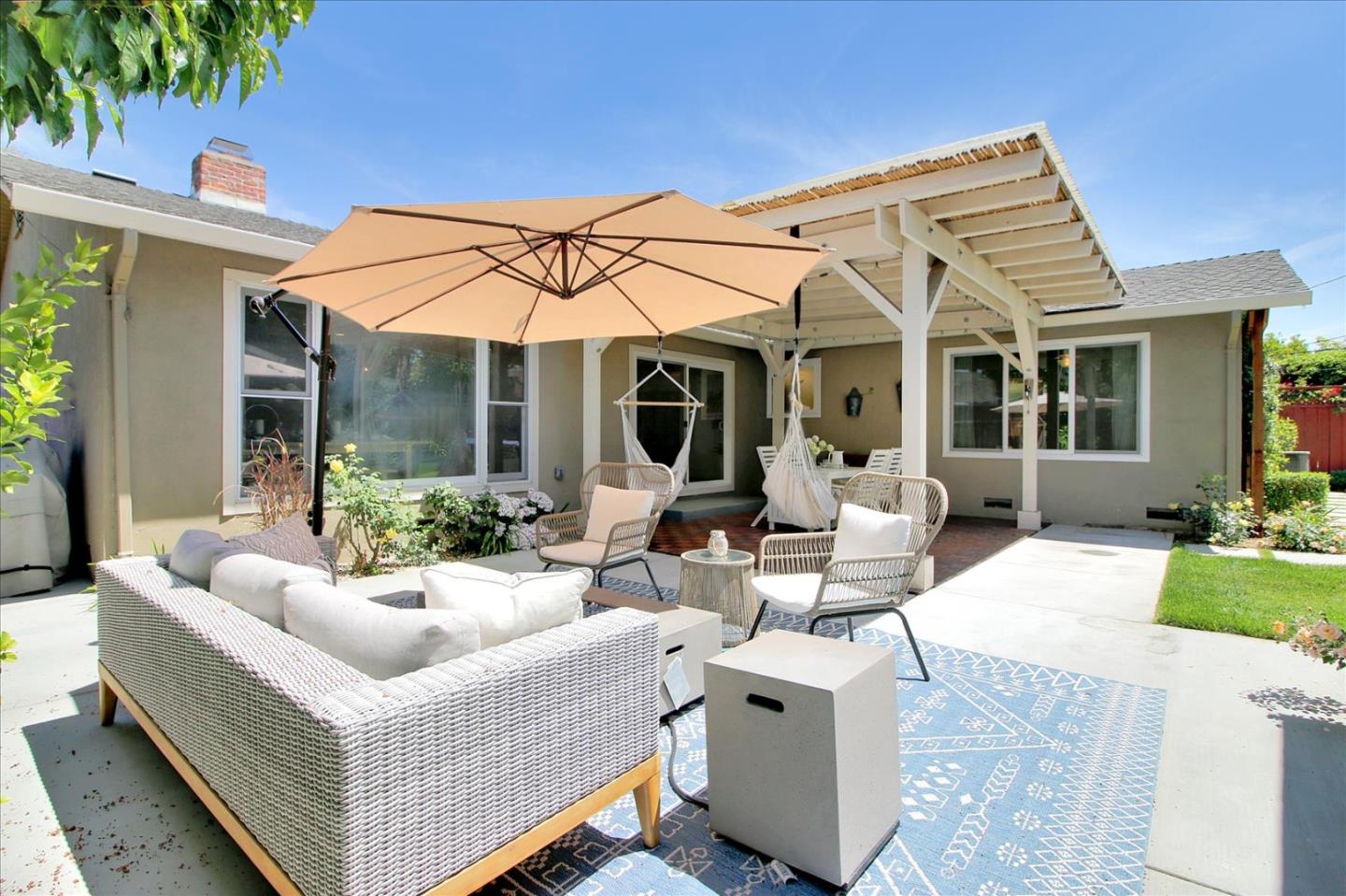 1435 Floyd Avenue Sunnyvale, CA 94087 - Photo 28 of 36 a view of a white house with floor to ceiling windows and potted plants