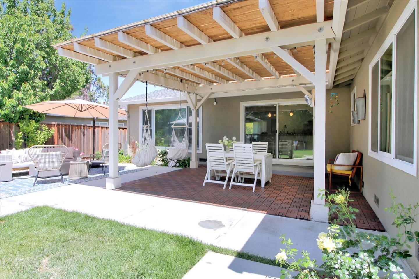 1435 Floyd Avenue Sunnyvale, CA 94087 - Photo 29 of 36 a view of a patio with a table and chairs under an umbrella