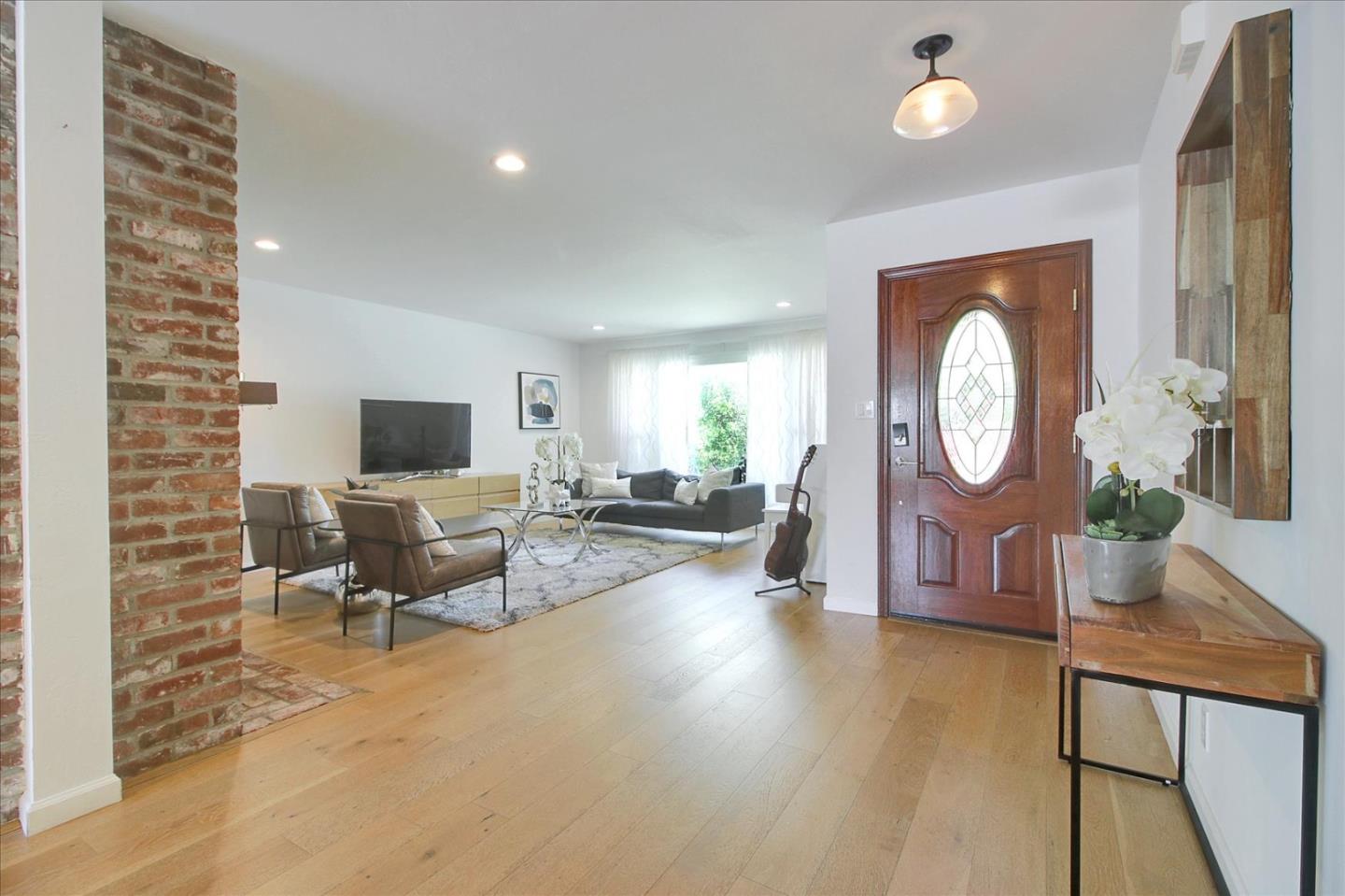 1435 Floyd Avenue Sunnyvale, CA 94087 - Photo 4 of 36 a living room with furniture a mirror and a flat screen tv