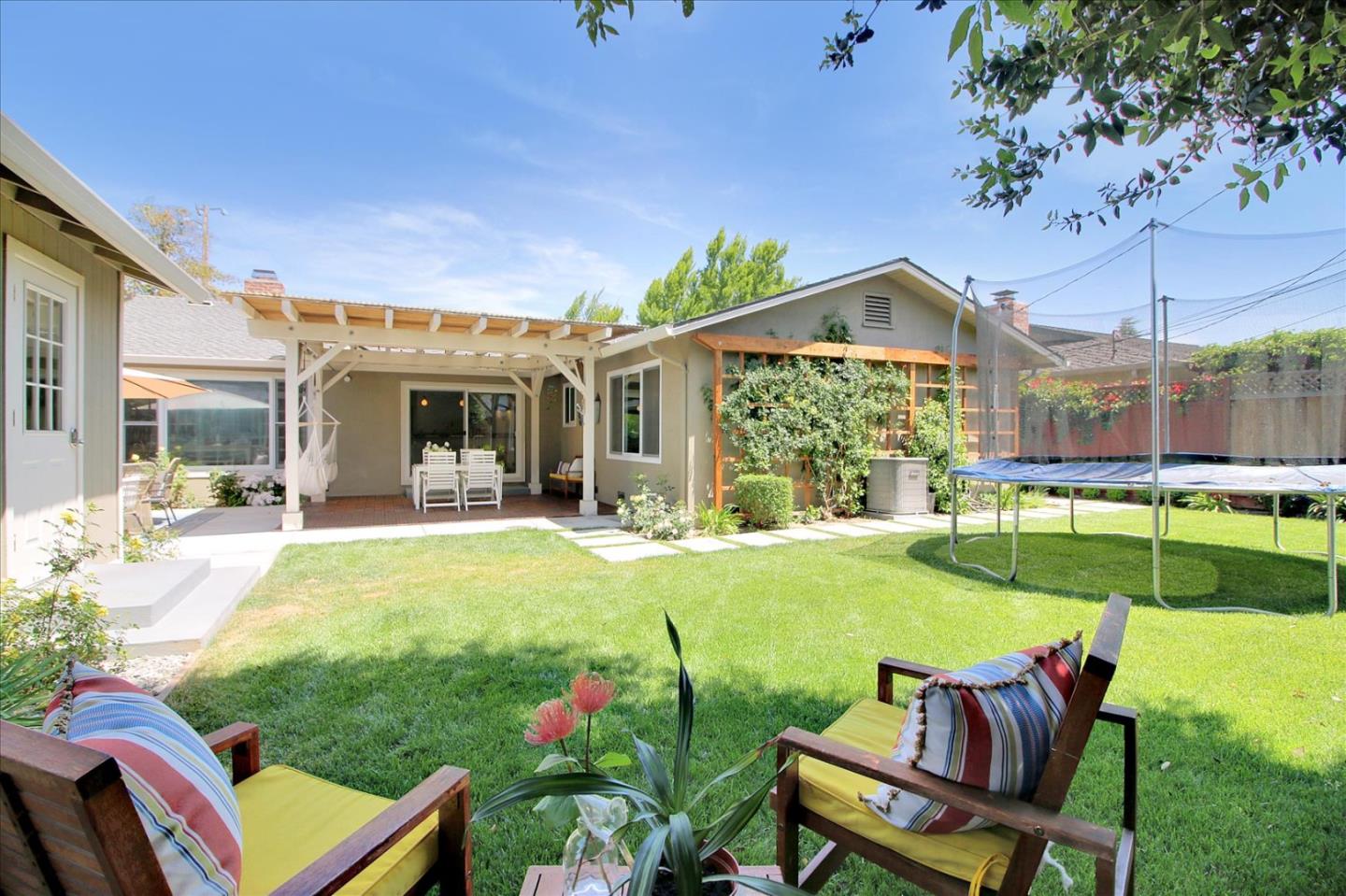 1435 Floyd Avenue Sunnyvale, CA 94087 - Photo 31 of 36 a view of a patio with table and chairs potted plants and a wooden fence