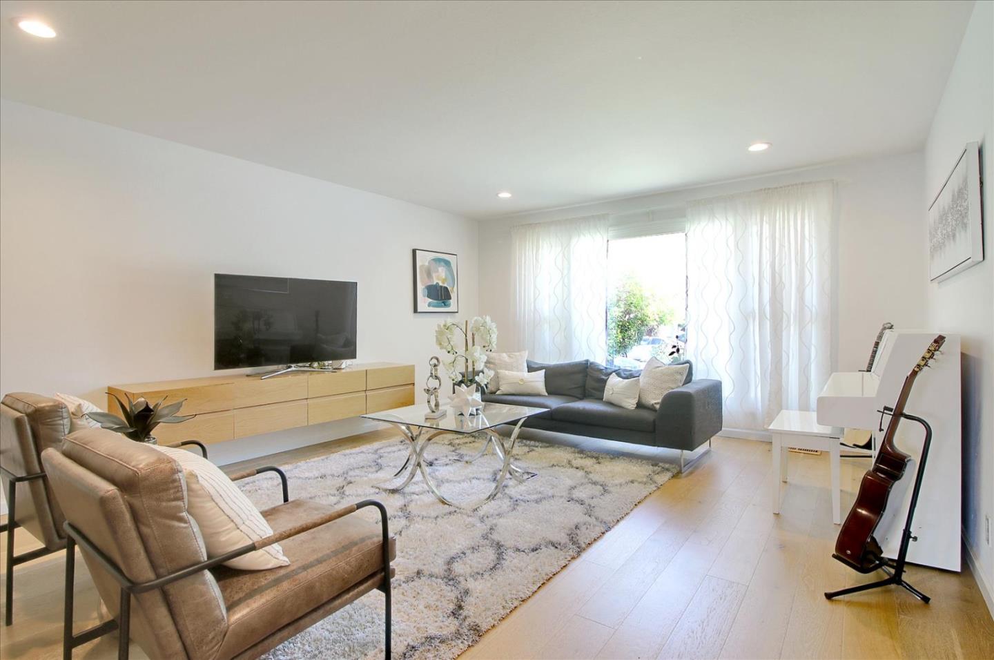 1435 Floyd Avenue Sunnyvale, CA 94087 - Photo 7 of 36 a living room with furniture gym equipment and a flat screen tv