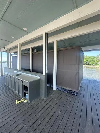 a view of living room kitchen with wooden floor and fence