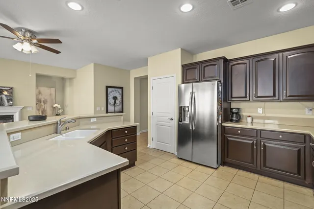 a kitchen with stainless steel appliances granite countertop a sink stove refrigerator and cabinets