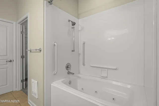 a white bath tub sitting next to a shower