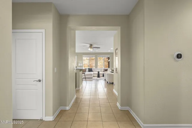 a hallway with a dining table and chairs