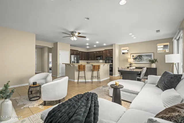 a living room with furniture and kitchen view