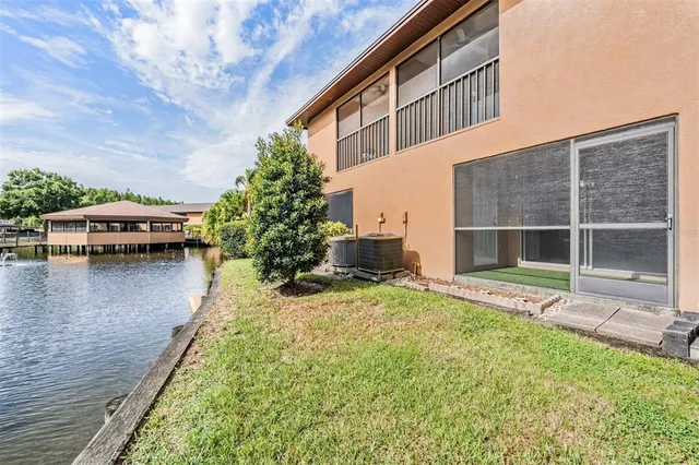 a view of a house with pool and sitting area