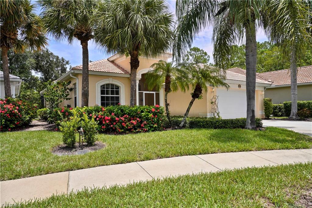 6522 Waverly Green Way Naples, FL 34110 - Photo 1 of 30 a view of a garden with palm trees