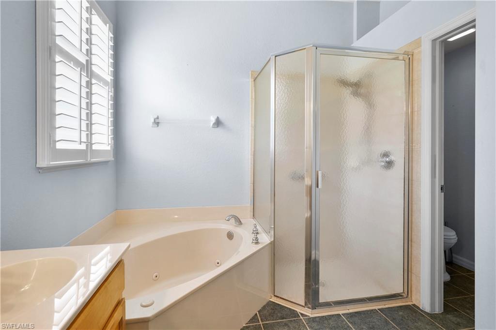 6522 Waverly Green Way Naples, FL 34110 - Photo 13 of 30 a bathroom with a bathtub and a shower