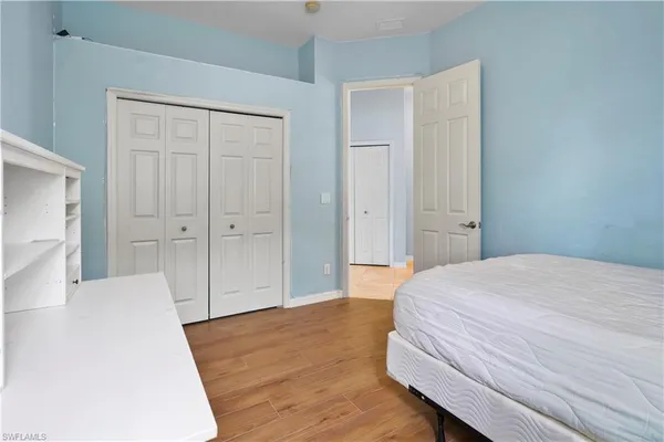 a bedroom with a bed and a dresser