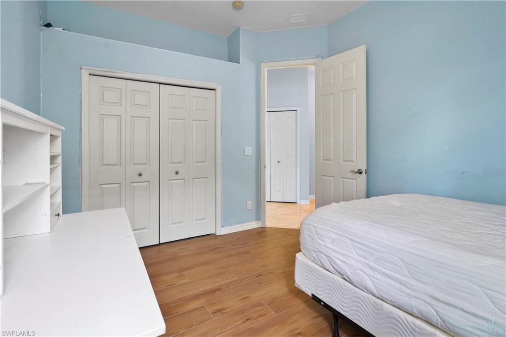6522 Waverly Green Way Naples, FL 34110 - Photo 14 of 30 a bedroom with a bed and a dresser