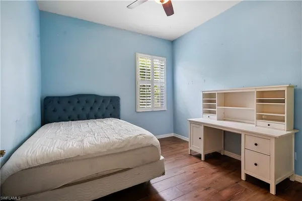 a bedroom with a bed and a desk