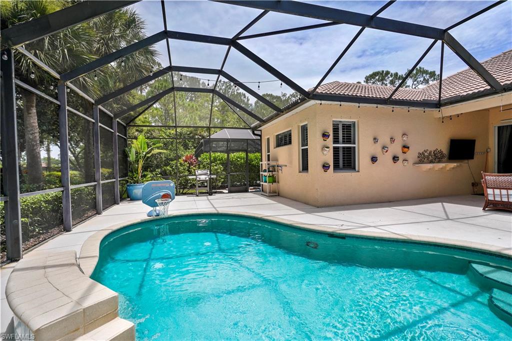 6522 Waverly Green Way Naples, FL 34110 - Photo 20 of 30 a view of a swimming pool with a patio